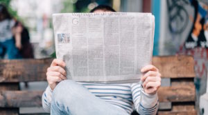 person holding newspaper